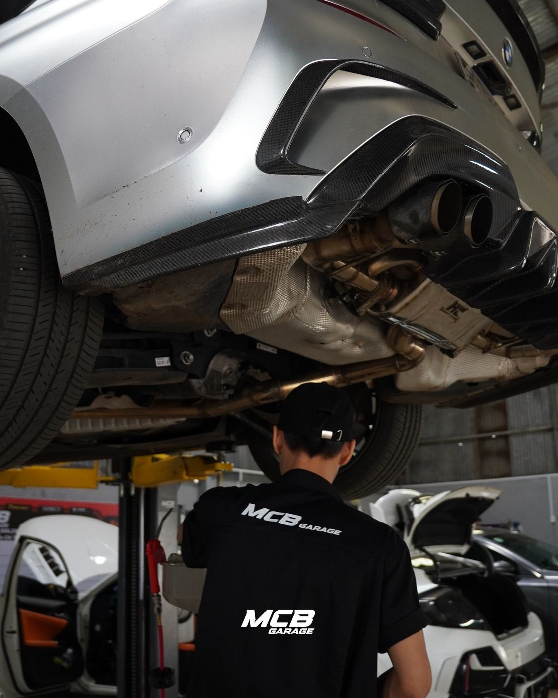 Kỹ thuật viên MCB Garage soát gầm xe trên cầu nâng